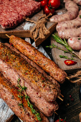 raw Lula kebab on skewers with spices on a cutting board light background. Lula kebab, traditional Caucasian dish. top view