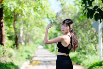 Sporty young woman stretching her arms while exercising outdoors.  Shot of a fit young woman stretching before a run outdoors. Healthy lifestyle.