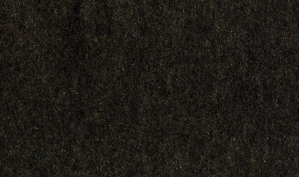 High resolution black, elegant uncoated paper texture scan with rough grain fiber and small dust particles with copy space for text for wallpapers, presentation, mockup materials