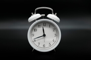 Old Vintage alarm clock on dark background,time flowing concept,analog clock