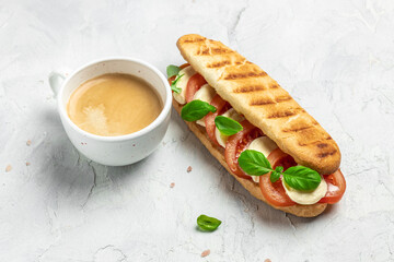 Pressed and toasted panini caprese with tomato, mozzarella and basil, Caprese Panini Sandwich. Delicious breakfast or snack, Clean eating, dieting, vegan food concept. top view