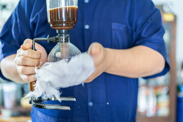 Making coffee with syphon method