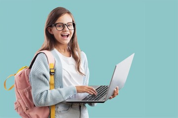 Portrait of smiling teen girl using a laptop computer, studying online