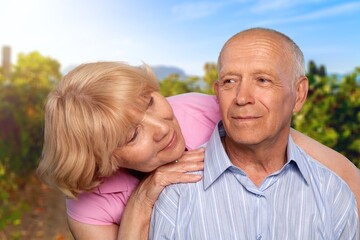 Fototapeta premium Portrait of happy senior couple smiling at natural background