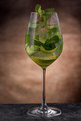 Mojito cocktail served in wine glass with mint 