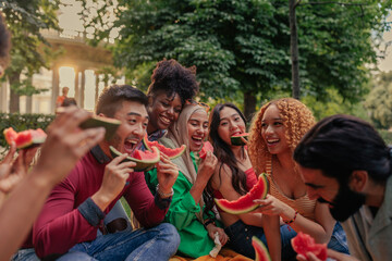 Cheerful multiracial friends holding pieces of watermelon