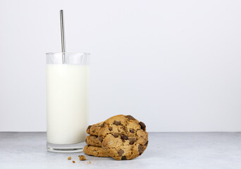 A glass of milk and cookies with chocolate cookies on a white background. Copy space.