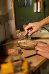 Female using power wood working tools graver, carving while crafting