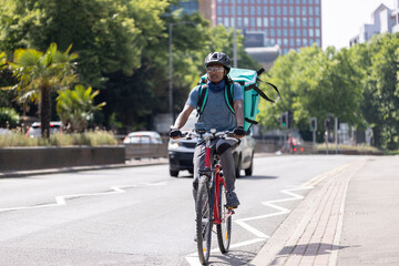 Obraz premium Courier On Bike Delivering Food In City