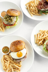 selection of many different burgers on restaurant table