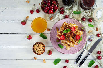 Delicious breakfast with belgian waffles. Waffels with strawberry and berry jam