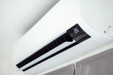 Air conditioner on white wall room interior background
