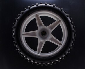 Baby car wheel on a black background close-up