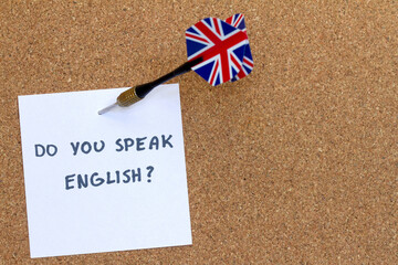 Aiming with dart with Uk flag at text 