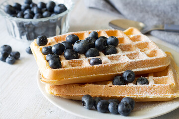 Delicious waffles with blueberries and powdered sugar