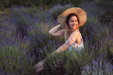 Beautiful Happy Woman in Lavender Field at Golden Hour at Sunset. Summer Evening in Lavender Field