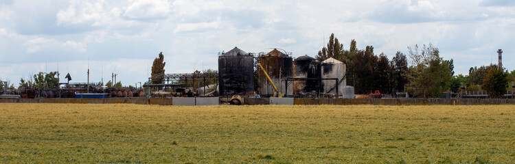 Fototapeta premium War in Ukraine. An oil depot in Ukraine after Russian missile attack. Bombing infrastructure in Ukraine. War of Russia against Ukraine.
