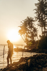 Male model, traveler, digital nomad, against the backdrop of palm trees and a tropical paradise landscape.