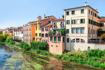 Fototapeta na wymiar Houses and water channel . Waterfront residential district in Padua Italy 