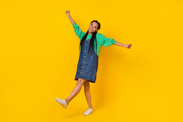 Full body portrait of cheerful overjoyed lady enjoy dancing clubbing isolated on yellow color background