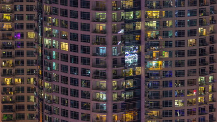Fototapeta na wymiar Evening view of exterior apartment recidential building timelapse with glowing windows