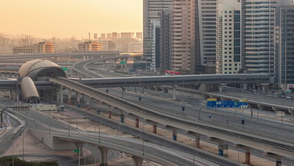 Futuristic building of Dubai metro station and luxury skyscrapers behind in Dubai Marina aerial timelapse, United Arab Emirates