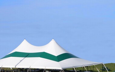 a green and white large luxury entertainment or wedding tent 
