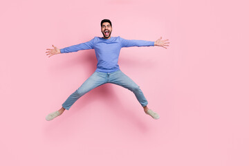 Full length photo of cheerful sweet man wear long sleeve shirt jumping high isolated pink color background