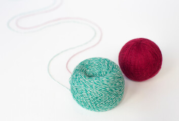 two skeins of multicolored wool yarn on an isolated white background. Close-up