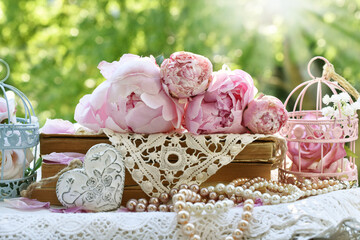 Vintage style still life with pink peonies lying on old books