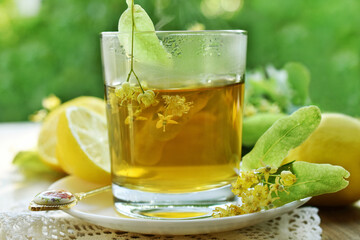 A glass of hot linden tea with lemon