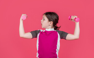 shocked kid hold fitness barbells on pink background