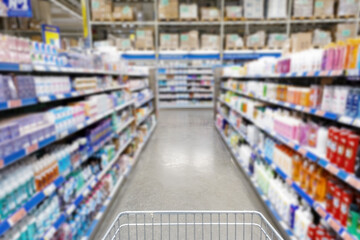 Blurred supermarket aisle with colorful shelves of merchandise