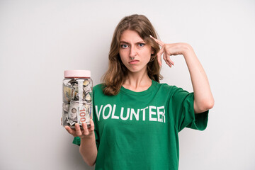 young girl with a donation banknotes bottle. volunteer concept