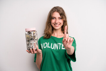 young girl with a donation banknotes bottle. volunteer concept
