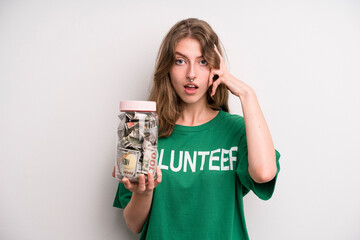 young girl with a donation banknotes bottle. volunteer concept
