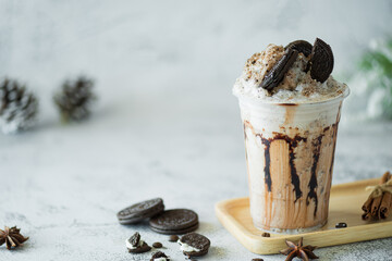 Chocolate milk shakes with cinnamon, chocolate pieces and various spices on stone background.