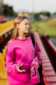 Portrait of a teenage student on the background of a school stadium