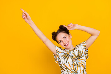 Photo of funny cheerful woman wear print t-shirt smiling dancing isolated yellow color background