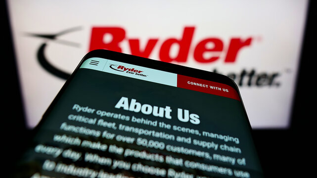 Stuttgart, Germany - 01-30-2022: Mobile phone with webpage of American transportation company Ryder System Inc. on screen in front of logo. Focus on top-left of phone display.