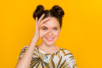 Photo of tricky funny woman wear print t-shirt showing okey cover eye isolated yellow color background