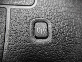 Close up Device Wifi button, leather pattern. 