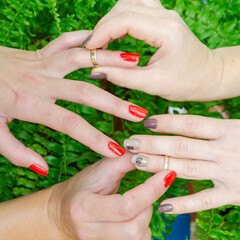 Close-up of the hands of a lesbian couple with wedding rings. girls exchange rings. LGBT. same sex love. Square image.