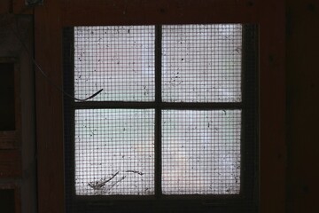 Vintage screened window in black and white.