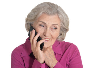 Beautiful senior woman talking on smartphone against white background