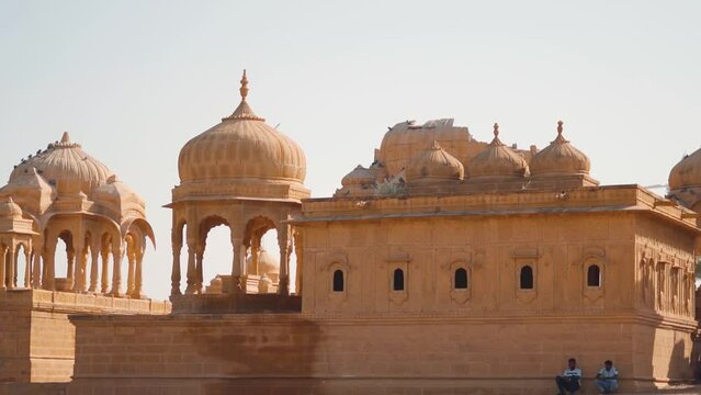 Royal chhatri cenotaphs at the Bada bagh in Jaisalmer, Rajasthan, India. Ancient cenotaph made out of sandstone in front of the clear blue sky. Ancient architecture made of sand stone at Jaisalmer.	
