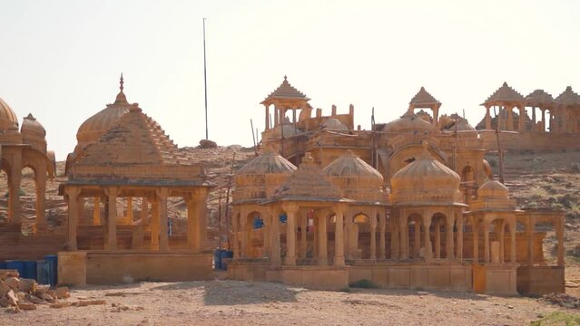 Royal chhatri cenotaphs at the Bada bagh in Jaisalmer, Rajasthan, India. Ancient cenotaph made out of sandstone in front of the clear blue sky. Ancient architecture made of sand stone at Jaisalmer.	