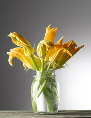 still life with courgette flowers on the wooden table - 513722759