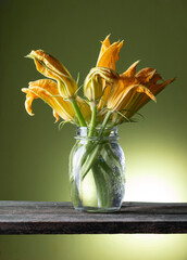 still life with courgette flowers on the wooden table - 513722761