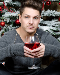 Christmas and New Year. An attractive guy is waiting for gifts.